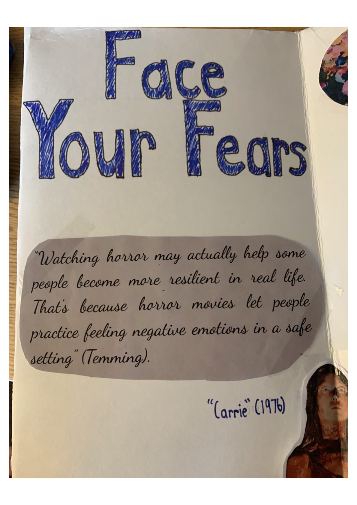 “Face Your Fears” in large blue letters. Text reads: “‘Watching horror may actually help some people become more resilient in real life. That’s because horror movies let people practice feeling negative emotions in a safe setting’ (Temming).” A picture from “‘Carrie’ (1976),”